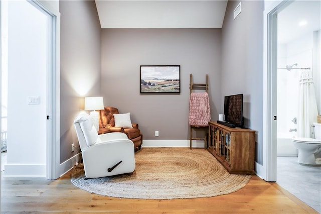 sitting room featuring baseboards and wood finished floors