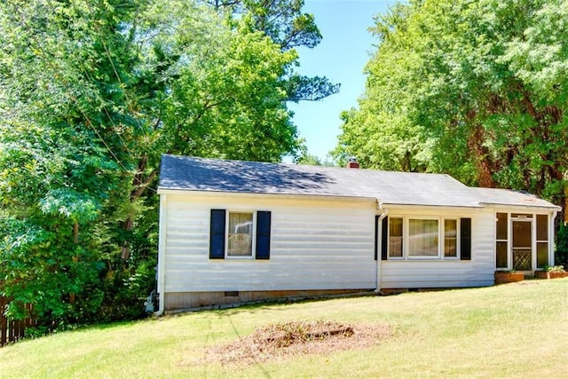 view of side of home featuring a yard