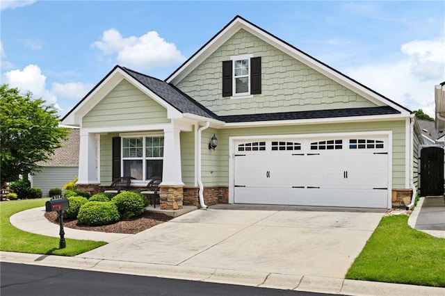 418 Thaxton Ln, Woodstock, GA 30188 - craftsman inspired home featuring covered porch, concrete driveway, stone siding, and a shingled roof