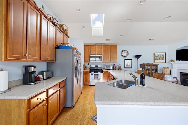 418 Thaxton Ln, Woodstock, GA 30188 - kitchen featuring appliances with stainless steel finishes, light wood-style floors, light countertops, brown cabinetry, and recessed lighting