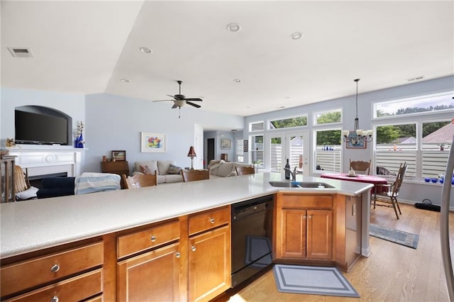 418 Thaxton Ln, Woodstock, GA 30188 - kitchen featuring black dishwasher, light wood finished floors, brown cabinetry, open floor plan, and light countertops