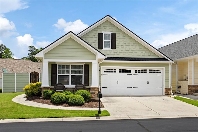 418 Thaxton Ln, Woodstock, GA 30188 - craftsman house featuring concrete driveway, stone siding, a garage, and a porch