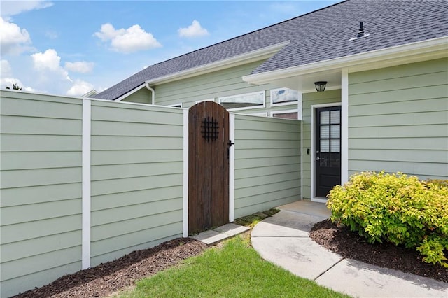 418 Thaxton Ln, Woodstock, GA 30188 - view of exterior entry featuring roof with shingles and a gate