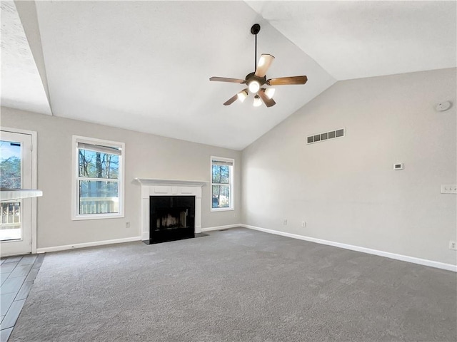 unfurnished living room with lofted ceiling, ceiling fan, and dark colored carpet