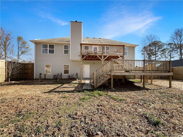 back of house featuring a wooden deck