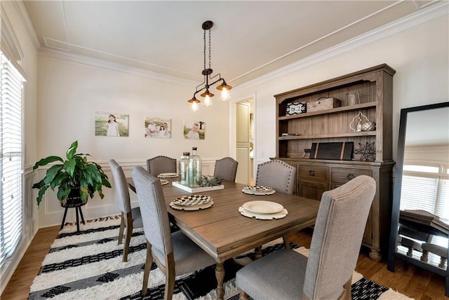 dining area with crown molding and dark wood-type flooring