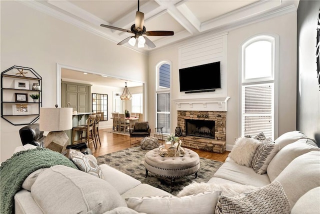 living room featuring crown molding, coffered ceiling, hardwood / wood-style floors, and ceiling fan