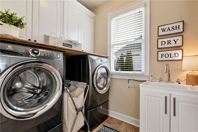 laundry area featuring cabinets, independent washer and dryer, tile patterned flooring, and sink