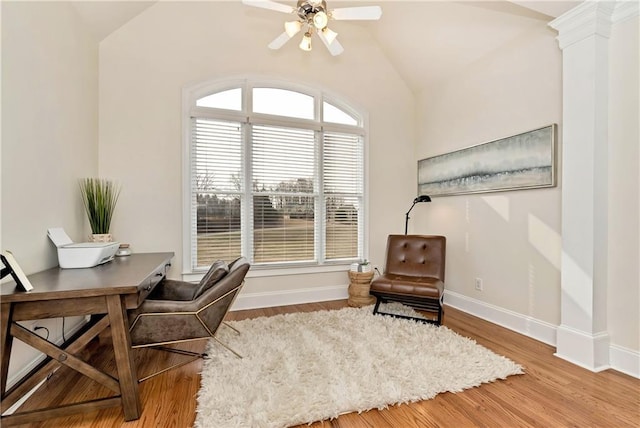 office space featuring decorative columns, lofted ceiling, hardwood / wood-style floors, and ceiling fan