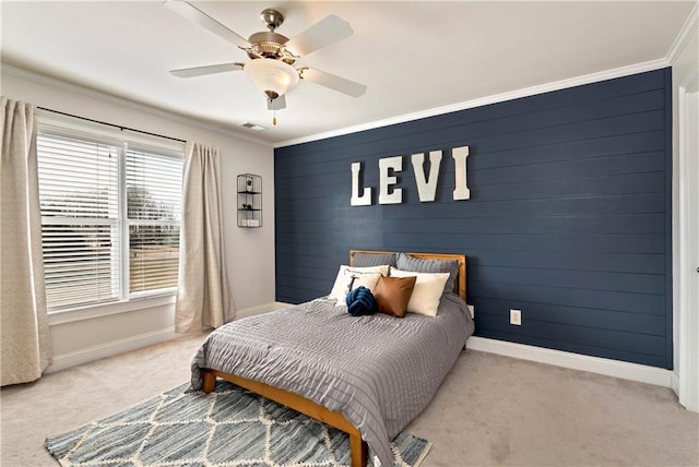 bedroom featuring ornamental molding, light colored carpet, and ceiling fan