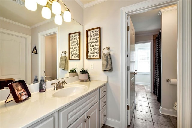 bathroom with ornamental molding, toilet, and vanity