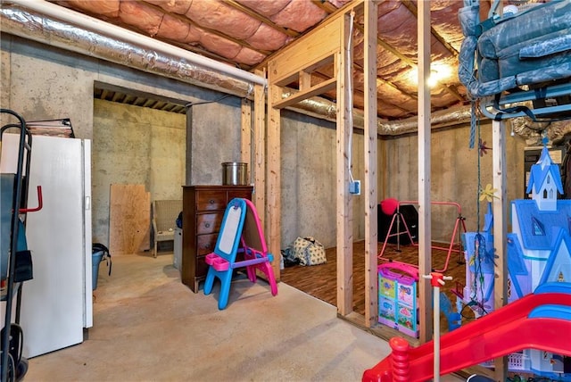 basement featuring white refrigerator