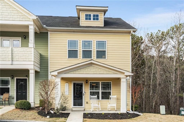 view of front of property with a balcony and covered porch