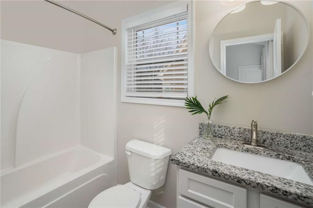 bathroom with toilet,  shower combination, and vanity