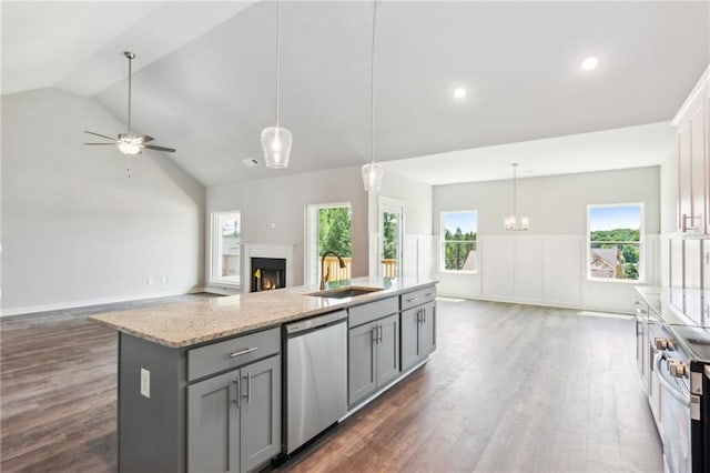 kitchen with gray cabinets, an island with sink, appliances with stainless steel finishes, and hanging light fixtures