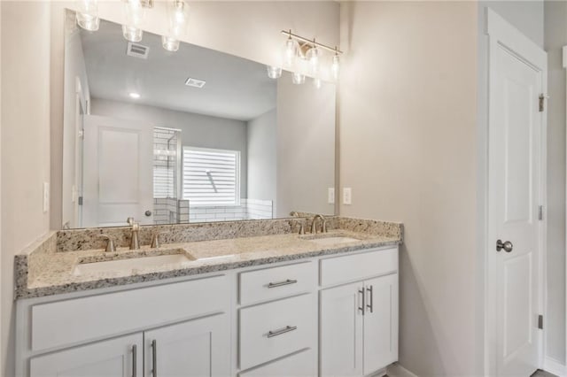 bathroom featuring vanity and a shower