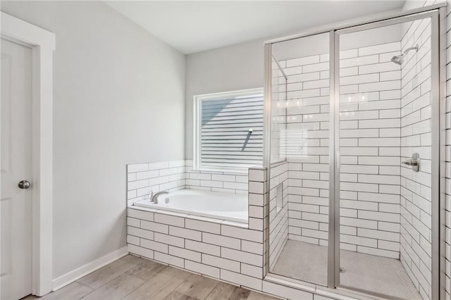 bathroom featuring hardwood / wood-style floors and independent shower and bath