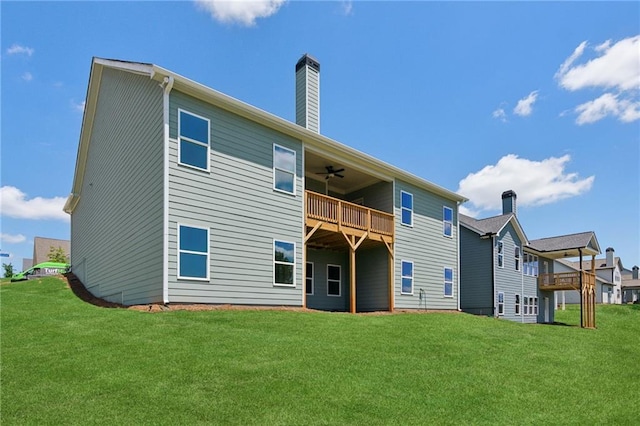 back of property featuring ceiling fan and a lawn