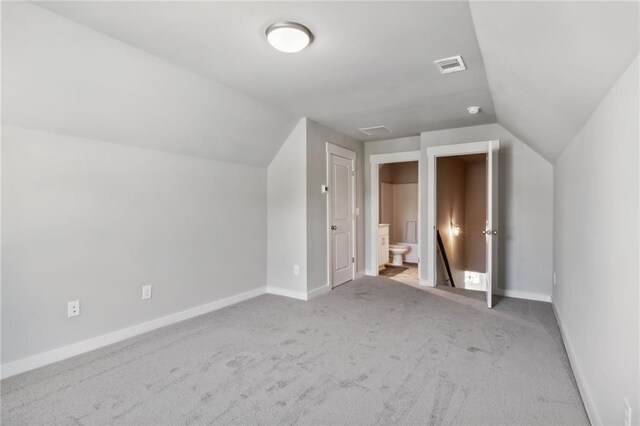 additional living space with lofted ceiling and light colored carpet