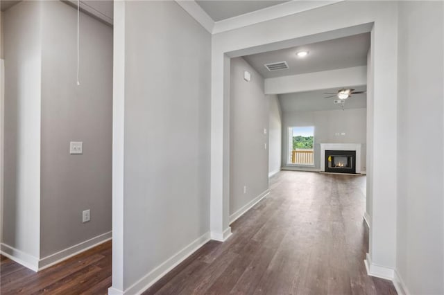 hall featuring crown molding and dark hardwood / wood-style flooring