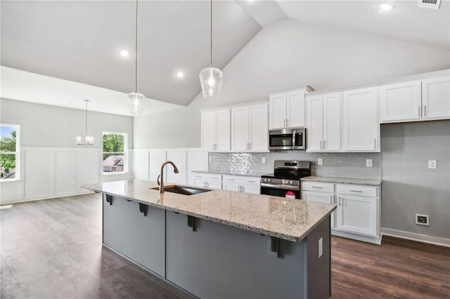 kitchen featuring white cabinetry, appliances with stainless steel finishes, sink, and pendant lighting