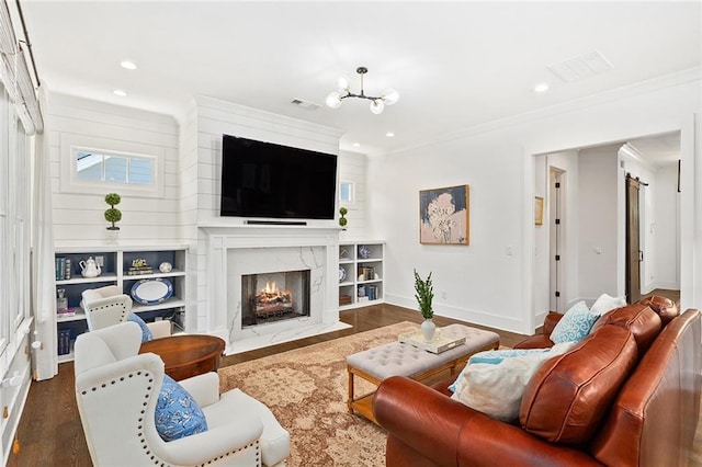 259 Sisson Ave, Atlanta, GA 30317 - living area with ornamental molding, wood finished floors, recessed lighting, a chandelier, and a premium fireplace