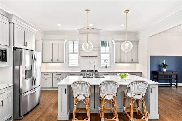 259 Sisson Ave, Atlanta, GA 30317 - kitchen featuring stainless steel appliances, a center island with sink, dark wood-style floors, hanging light fixtures, and ornamental molding