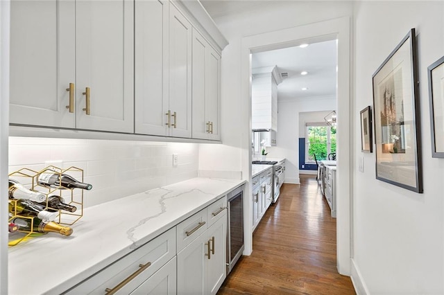 259 Sisson Ave, Atlanta, GA 30317 - kitchen featuring dark wood-style flooring, decorative backsplash, beverage cooler, crown molding, and light stone countertops