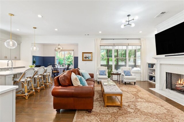 259 Sisson Ave, Atlanta, GA 30317 - living area with dark wood-style flooring, ornamental molding, a premium fireplace, and recessed lighting