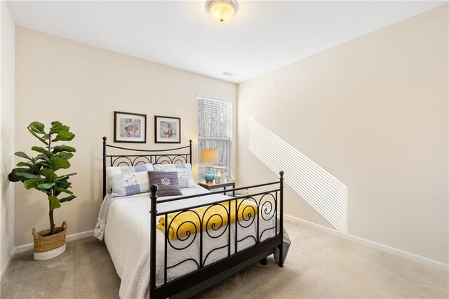 bedroom with light colored carpet, a raised ceiling, ceiling fan, and ornamental molding