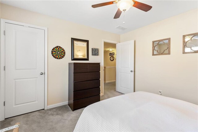 interior space with light colored carpet and ceiling fan