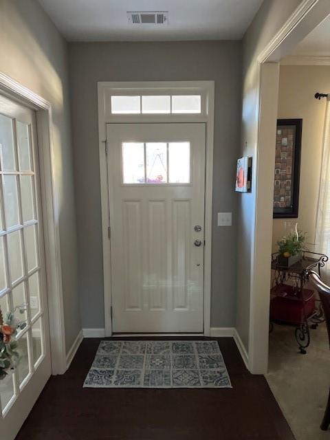 entryway featuring crown molding and dark hardwood / wood-style flooring