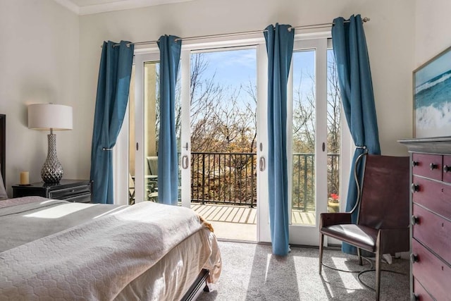 bedroom with multiple windows, access to outside, and light colored carpet