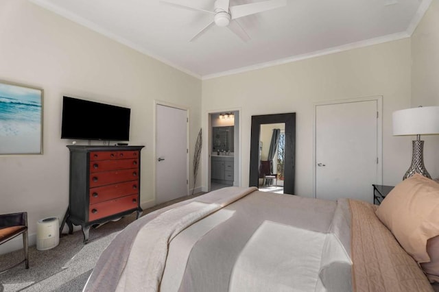 bedroom featuring connected bathroom, crown molding, carpet floors, and ceiling fan