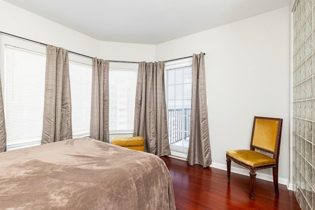 bedroom with dark hardwood / wood-style flooring