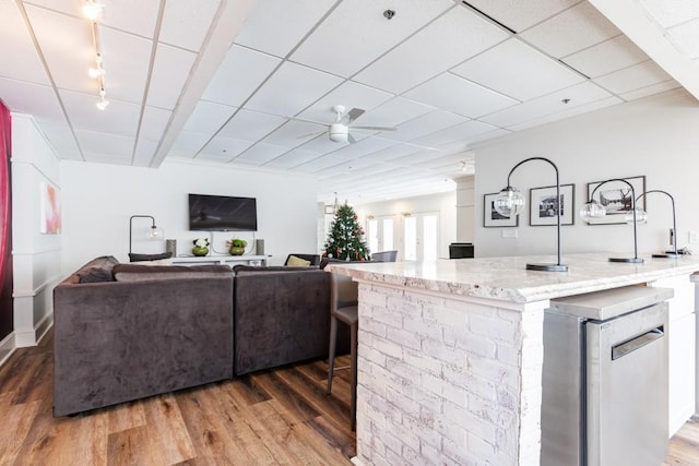 living room with ceiling fan and hardwood / wood-style floors