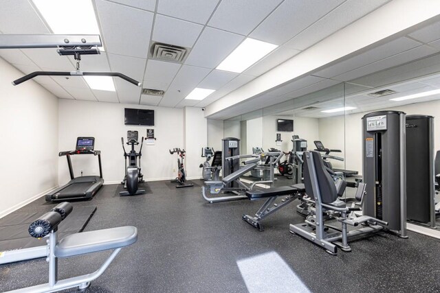 exercise room with a paneled ceiling