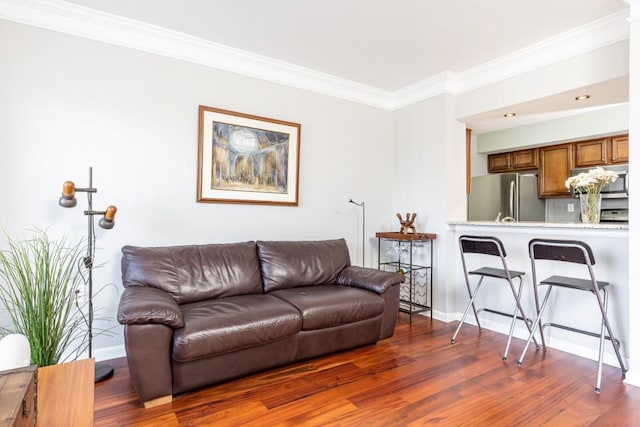 living room with dark wood-type flooring and ornamental molding