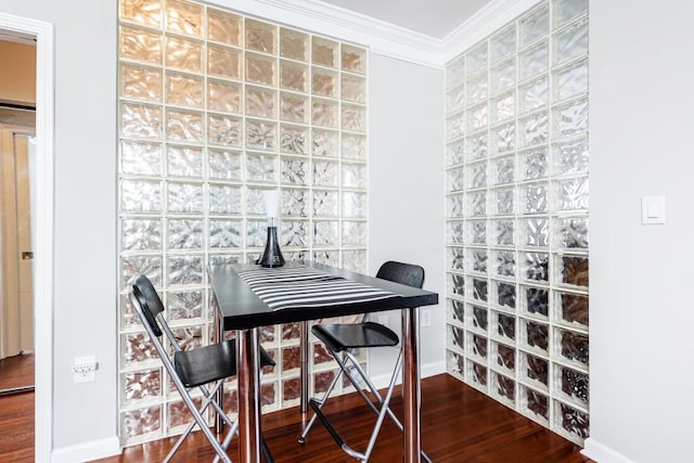 dining room with hardwood / wood-style flooring and ornamental molding