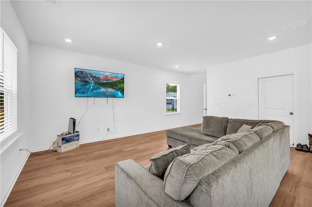 living area with recessed lighting, light wood-style floors, and baseboards