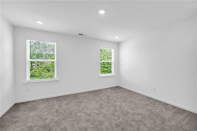 carpeted empty room with baseboards and recessed lighting