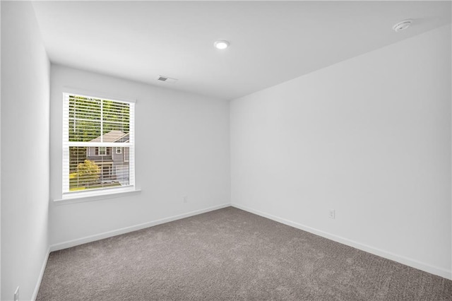 unfurnished room with carpet floors and baseboards