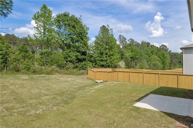 view of yard with fence and a patio
