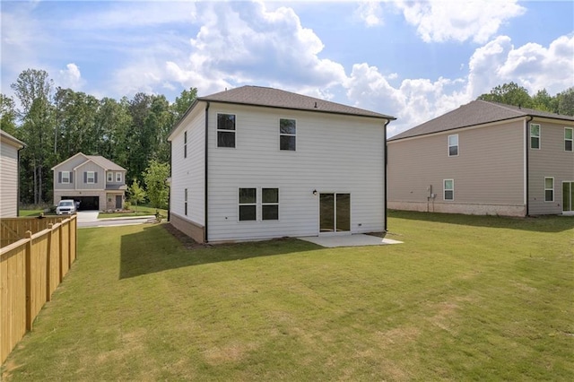 back of house featuring a lawn, fence, and a patio