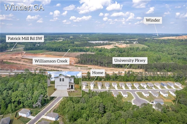 drone / aerial view featuring a forest view
