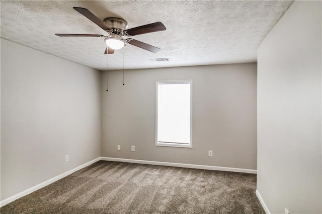 carpeted empty room featuring a textured ceiling and ceiling fan