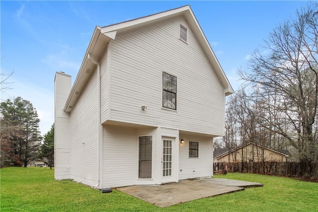 back of property with a patio area and a yard