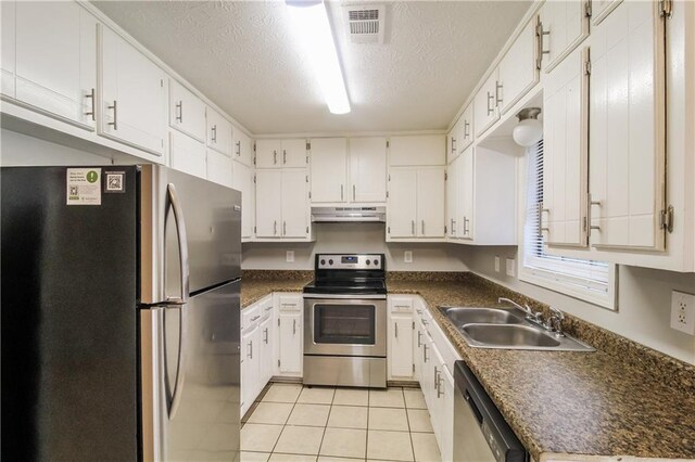 kitchen featuring sink, white cabinets, stainless steel appliances, and light tile patterned floors