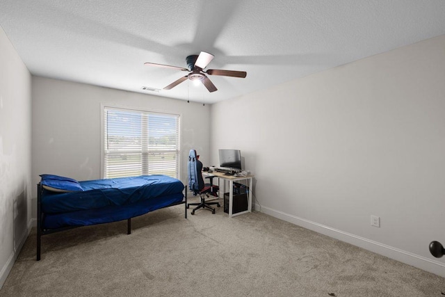 bedroom with carpet floors, a ceiling fan, a textured ceiling, and visible vents