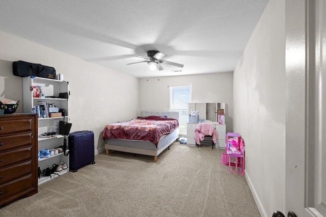 bedroom featuring baseboards, carpet flooring, a textured ceiling, and a ceiling fan